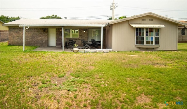 1906 N 60th St, Killeen, TX 76543 - rear view of property with a patio, a lawn, brick siding, and metal roof