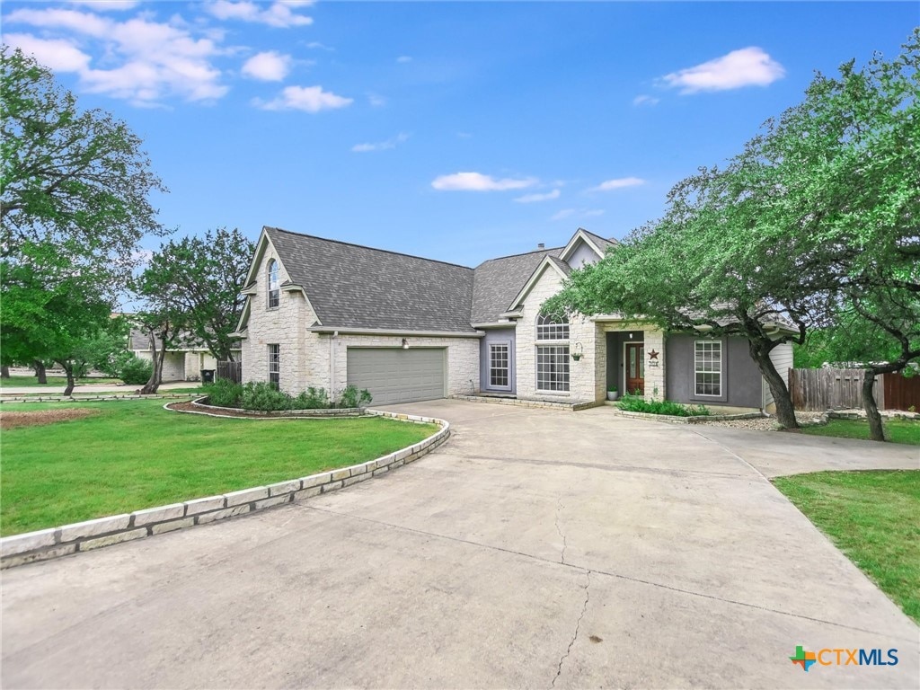 view of front of house with a garage and a front lawn