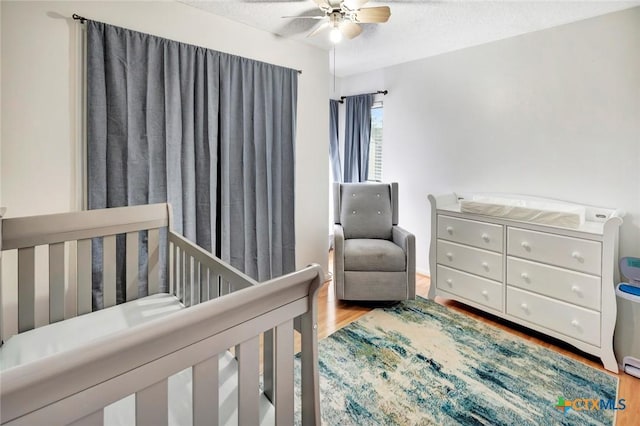 108 Bridle Ln, Victoria, TX 77904 - bedroom with wood finished floors, a textured ceiling, and a ceiling fan