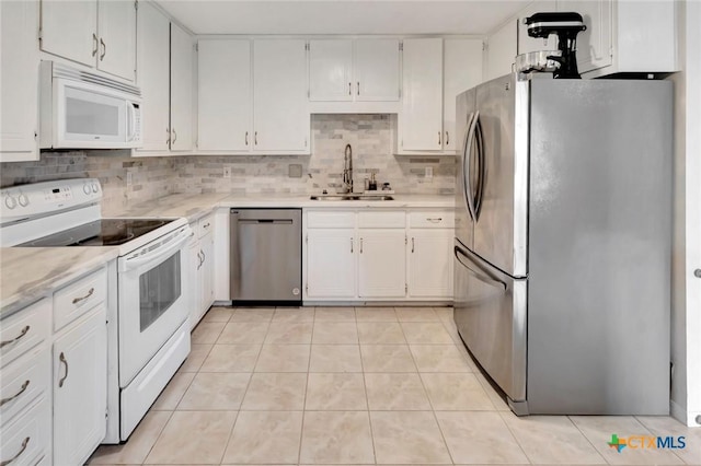 108 Bridle Ln, Victoria, TX 77904 - kitchen with stainless steel appliances, a sink, light countertops, tasteful backsplash, and light tile patterned floors