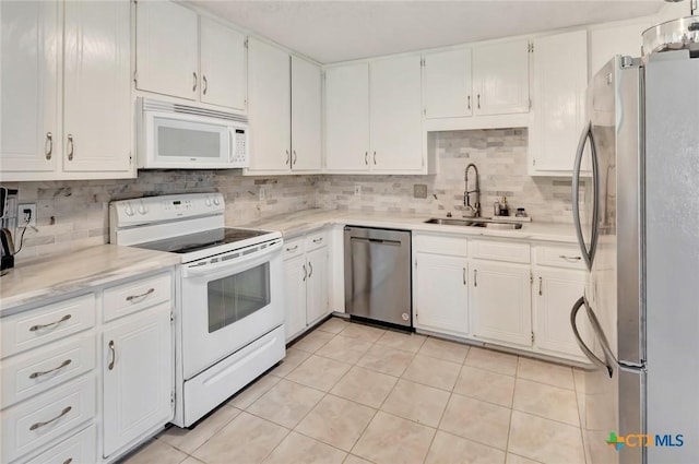 108 Bridle Ln, Victoria, TX 77904 - kitchen featuring stainless steel appliances, a sink, backsplash, and light countertops
