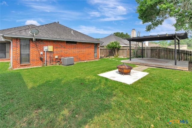 108 Bridle Ln, Victoria, TX 77904 - view of yard featuring a fire pit, cooling unit, a wooden deck, and a patio