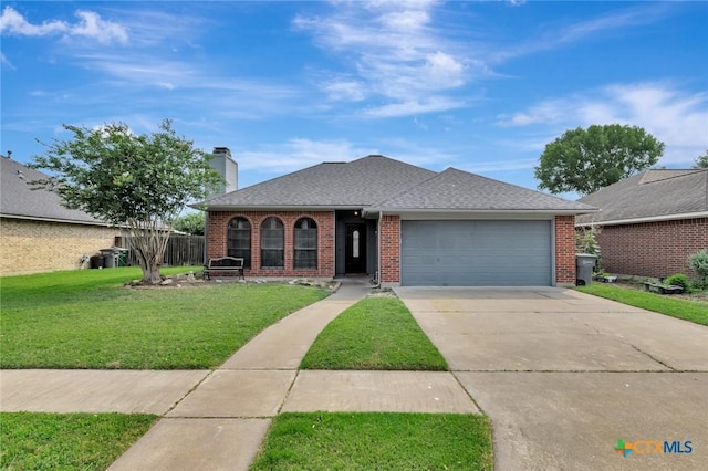108 Bridle Ln, Victoria, TX 77904 - view of front facade with a garage, a front lawn, driveway, and brick siding