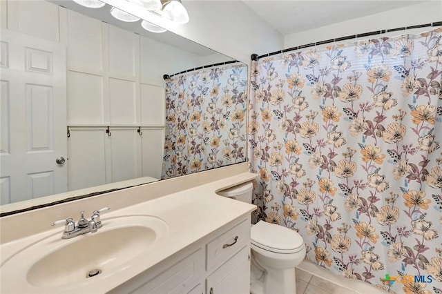 108 Bridle Ln, Victoria, TX 77904 - bathroom featuring vanity, toilet, tile patterned floors, and a shower with shower curtain