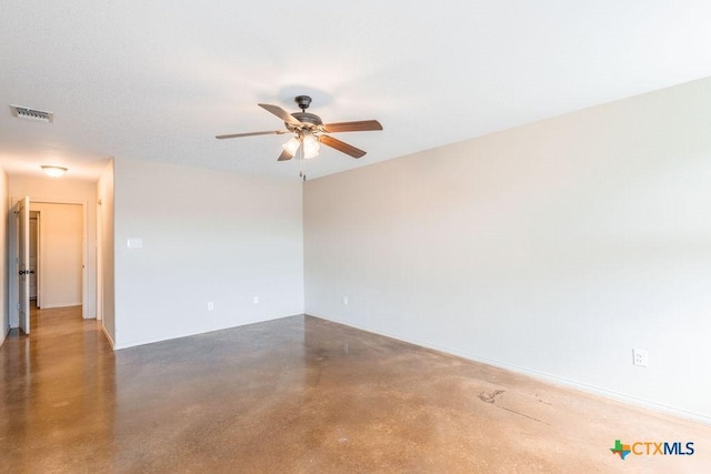 empty room featuring ceiling fan, concrete floors, and visible vents