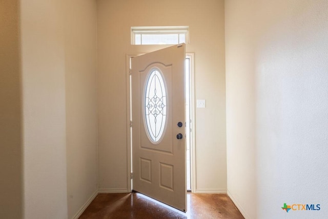 foyer featuring baseboards