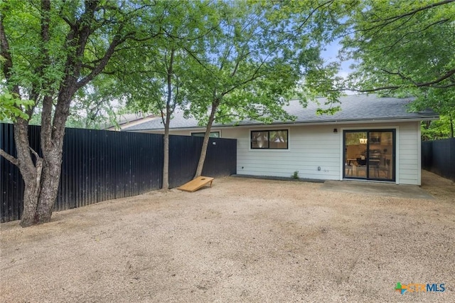 rear view of property with fence