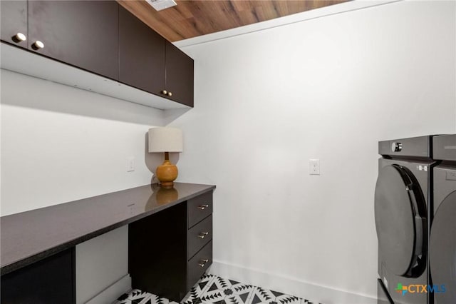 laundry area featuring cabinet space, washing machine and clothes dryer, baseboards, and tile patterned floors