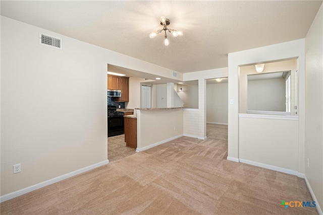 kitchen featuring tasteful backsplash, black range with electric cooktop, a notable chandelier, kitchen peninsula, and light colored carpet