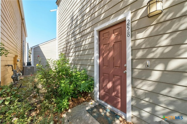 view of exterior entry with central AC unit