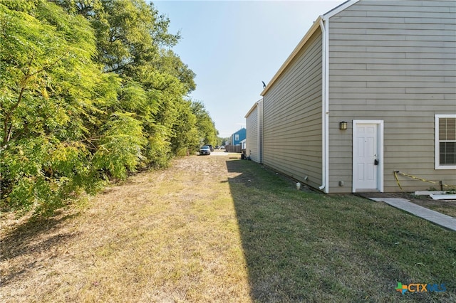 view of property exterior featuring a lawn