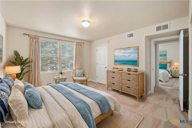 bedroom with baseboards and visible vents