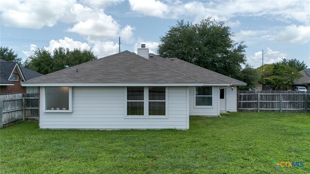 2810 Scottsdale Dr, Killeen, TX 76543 - back of property featuring a fenced backyard, a chimney, and roof with shingles