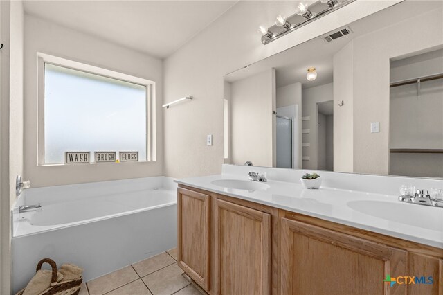2810 Scottsdale Dr, Killeen, TX 76543 - bathroom with a garden tub, double vanity, tile patterned flooring, and a stall shower