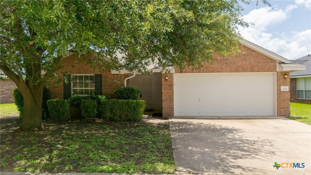 2810 Scottsdale Dr, Killeen, TX 76543 - view of front of home featuring brick siding, a garage, driveway, and a front lawn