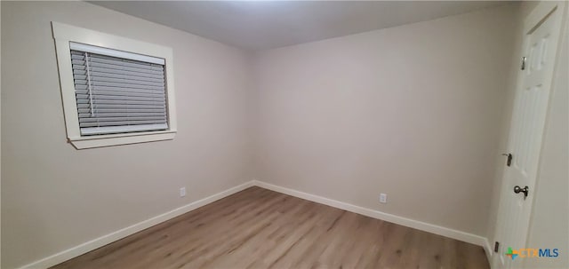 unfurnished room featuring light hardwood / wood-style floors