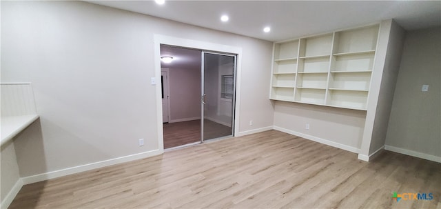 unfurnished bedroom featuring light wood-type flooring and a closet