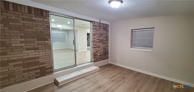 spare room with wood-type flooring