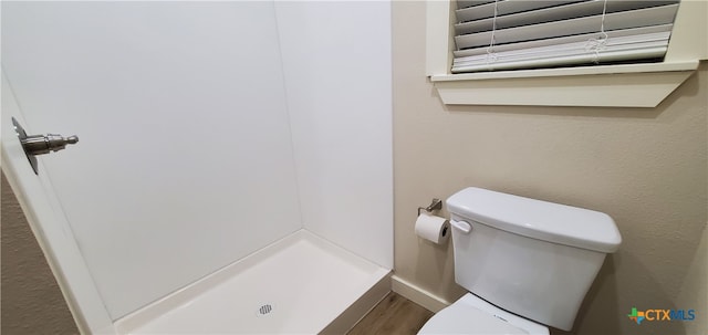 bathroom with hardwood / wood-style flooring and toilet