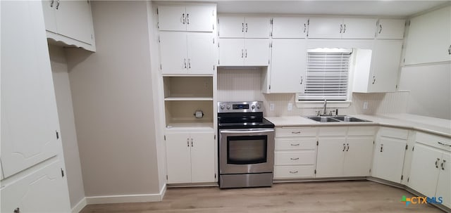 kitchen with decorative backsplash, light wood-type flooring, stainless steel electric stove, sink, and white cabinets