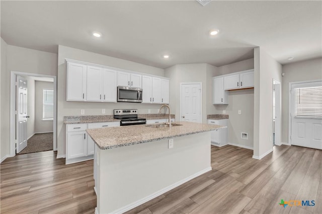2358 Aylesbury Dr, Copperas Cove, TX 76522 - kitchen featuring appliances with stainless steel finishes, light wood-style flooring, white cabinets, and recessed lighting