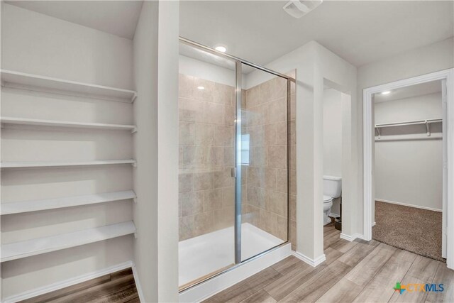 2358 Aylesbury Dr, Copperas Cove, TX 76522 - bathroom featuring a spacious closet, a shower stall, and wood finished floors