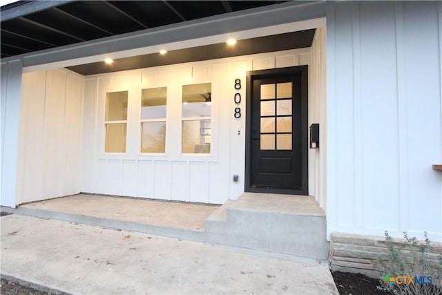 doorway to property featuring board and batten siding