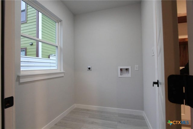 washroom featuring hookup for a washing machine, light wood-style flooring, hookup for an electric dryer, laundry area, and baseboards