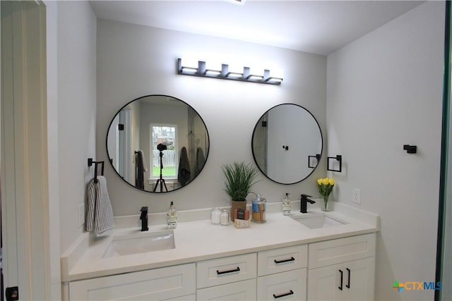 full bathroom with double vanity and a sink