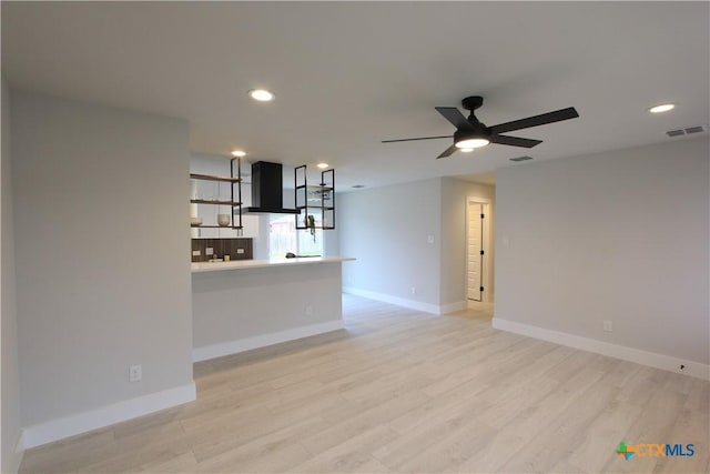 unfurnished living room featuring light wood finished floors, baseboards, visible vents, and recessed lighting