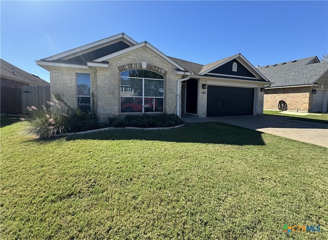 ranch-style house with a garage and a front yard