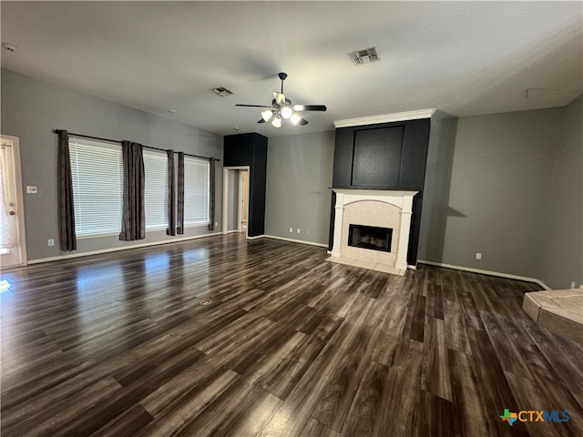 unfurnished living room featuring ceiling fan and dark wood-type flooring