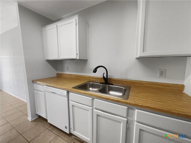 kitchen with white cabinetry, dishwasher, light tile patterned flooring, and sink