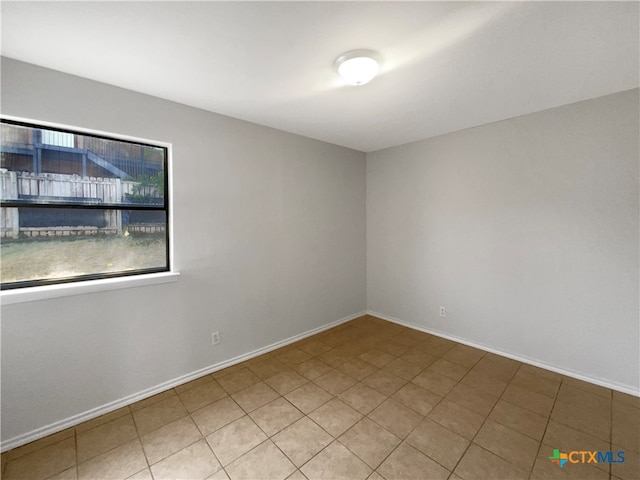 unfurnished room featuring tile patterned flooring