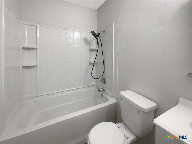 full bathroom featuring tiled shower / bath, vanity, and toilet