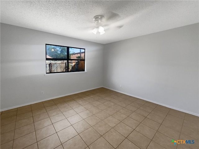 tiled spare room with ceiling fan and a textured ceiling