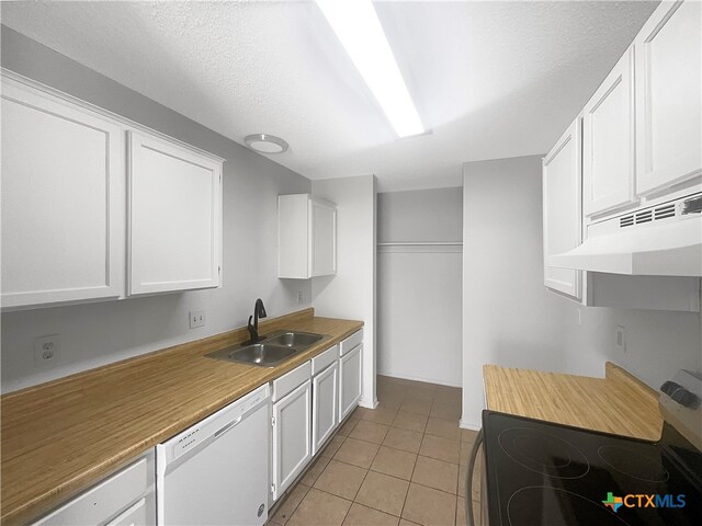 kitchen with stove, white cabinets, sink, light tile patterned floors, and dishwasher