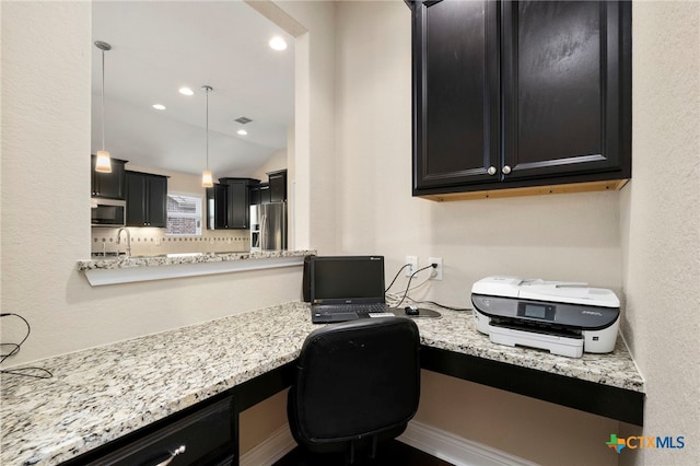 office space with visible vents, built in desk, and a sink