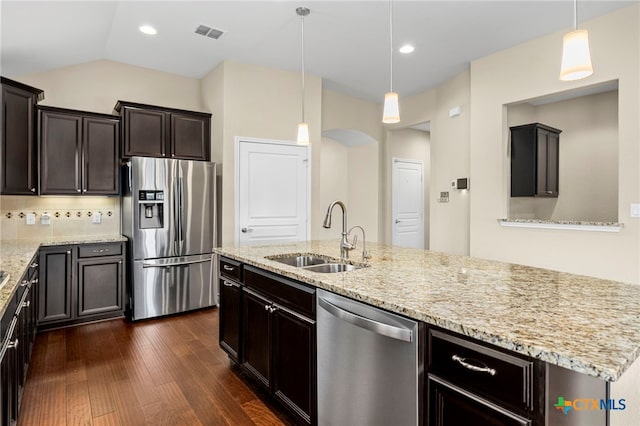 kitchen featuring dark wood-style floors, light stone countertops, a sink, stainless steel appliances, and visible vents
