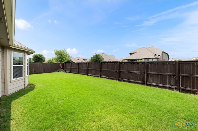 view of yard with a fenced backyard