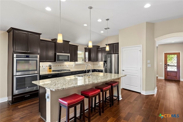 kitchen with dark wood finished floors, stainless steel appliances, and a sink