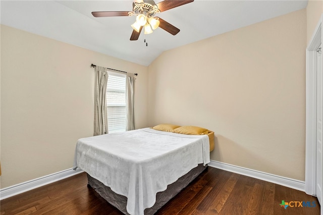 bedroom featuring dark wood finished floors, a ceiling fan, vaulted ceiling, and baseboards