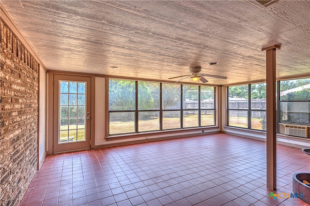 unfurnished sunroom featuring ceiling fan, cooling unit, and wood ceiling