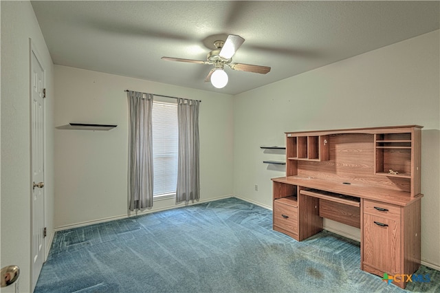 unfurnished office with ceiling fan, dark carpet, and a textured ceiling