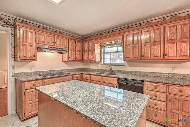 kitchen with sink, a center island, light stone counters, light tile patterned floors, and black appliances