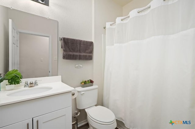 212 Gunther Way, Taylor, TX 76574 - bathroom with vanity, toilet, and a shower with shower curtain