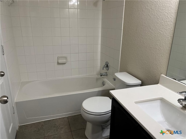 full bathroom with tiled shower / bath combo, vanity, tile patterned flooring, and toilet