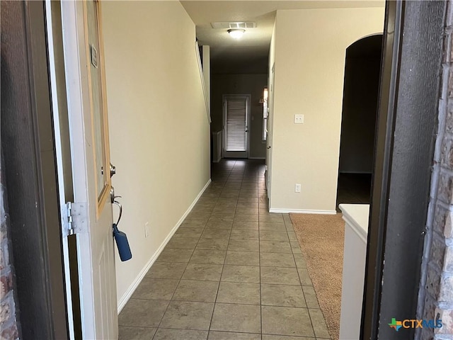 hall featuring tile patterned flooring