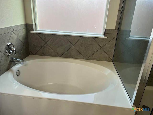 bathroom featuring a tub to relax in