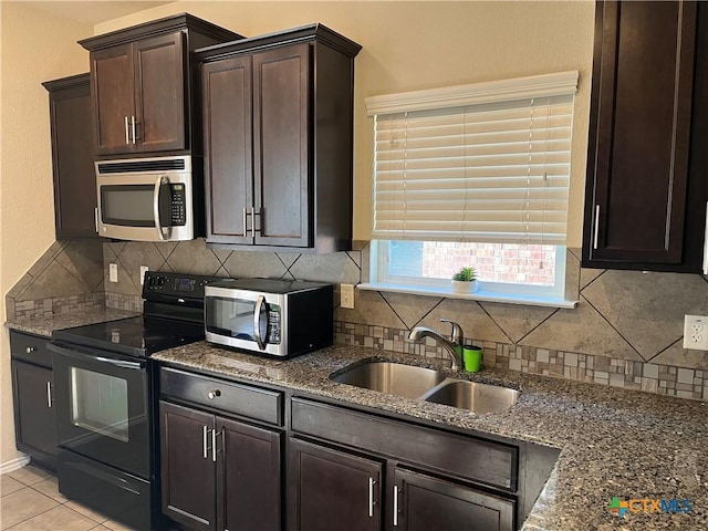 kitchen featuring light tile patterned flooring, sink, dark brown cabinets, black / electric stove, and dark stone counters